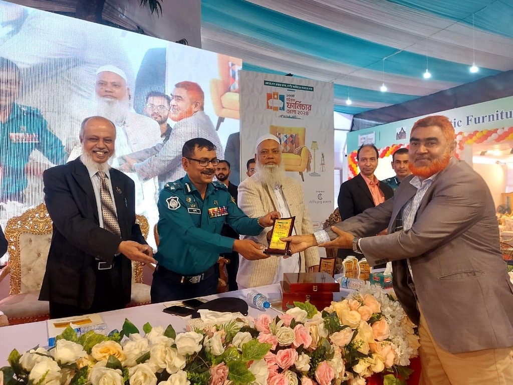 Heaven Furniture Mart founder receiving a plaque on stage at the 14th Chattogram Furniture Fair 2024